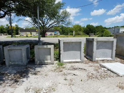 Row of Texas Precast concrete catch basins in the manufacturing yard
