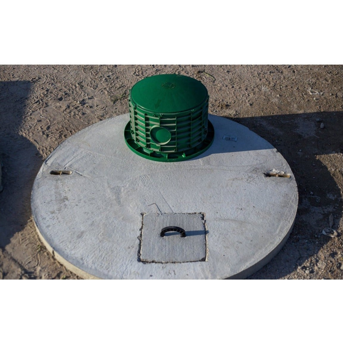 Green riser installed on a Texas Precast round concrete tank lid