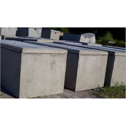 Row of Texas Precast rectangular concrete interceptor tanks in the manufacturing yard