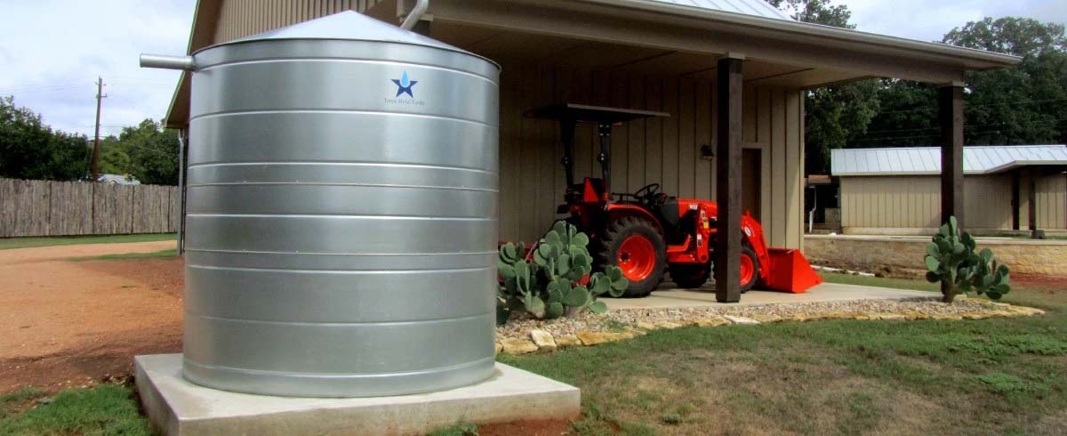 Texas Metal Tanks galvanized rainwater harvesting tank next to a rural home