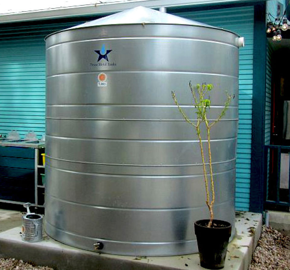 Texas Metal Tanks galvanized steel cistern installed next to a home