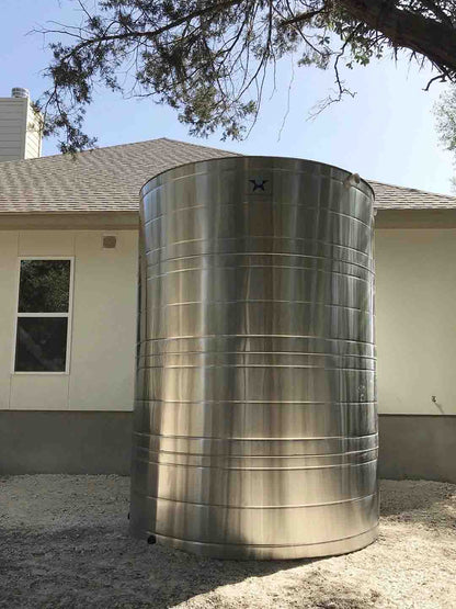Texas Metal Tanks stainless steel well water storage tank next to a home
